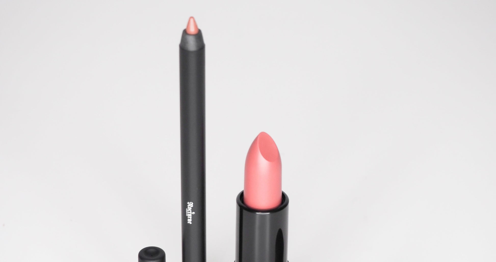 Lipstick and lip liner with 'Sculpted' branding on a white background